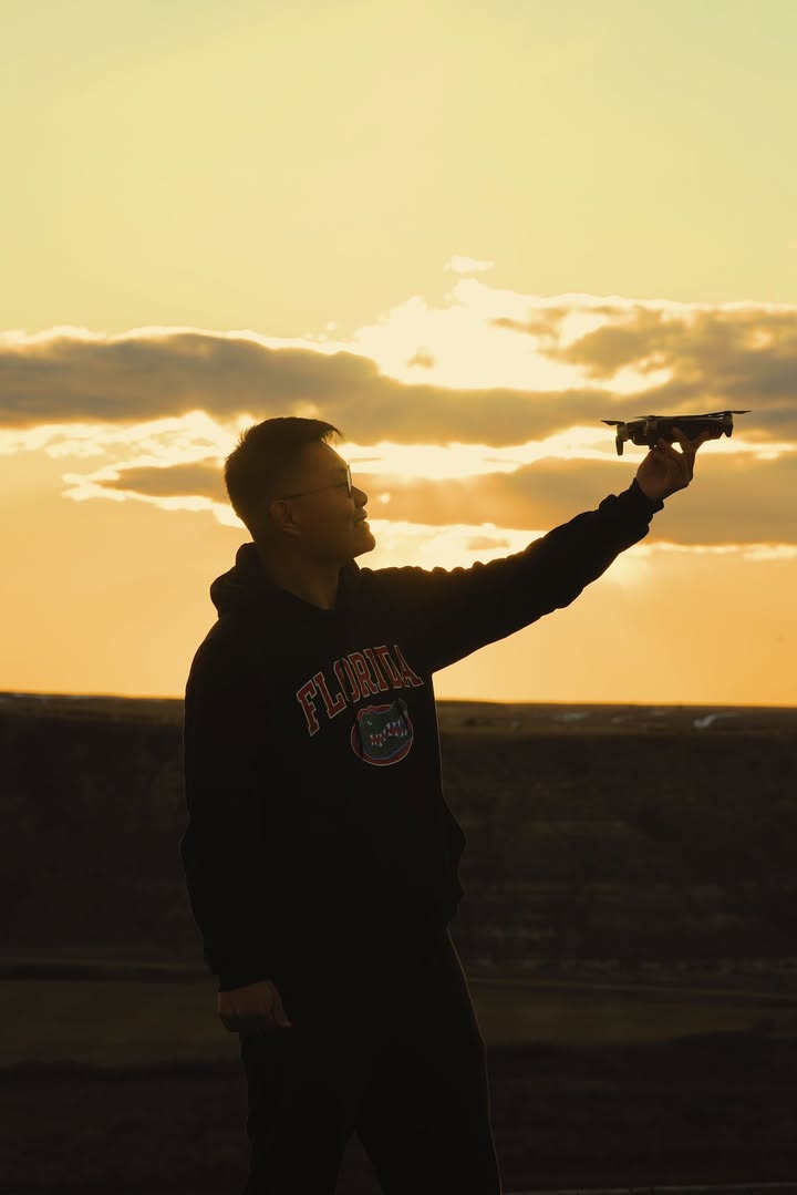 Aeroreel Media founder Andy flying a drone at sunset
